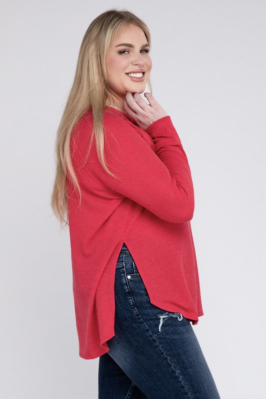 A woman in a Plus Melange Baby Waffle Long Sleeve Top and jeans posing with her hand on her hip, smiling.