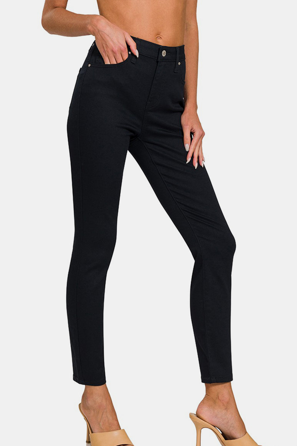 A person wearing the Zenana Full Size High-Rise Skinny Jeans with a slimming effect.