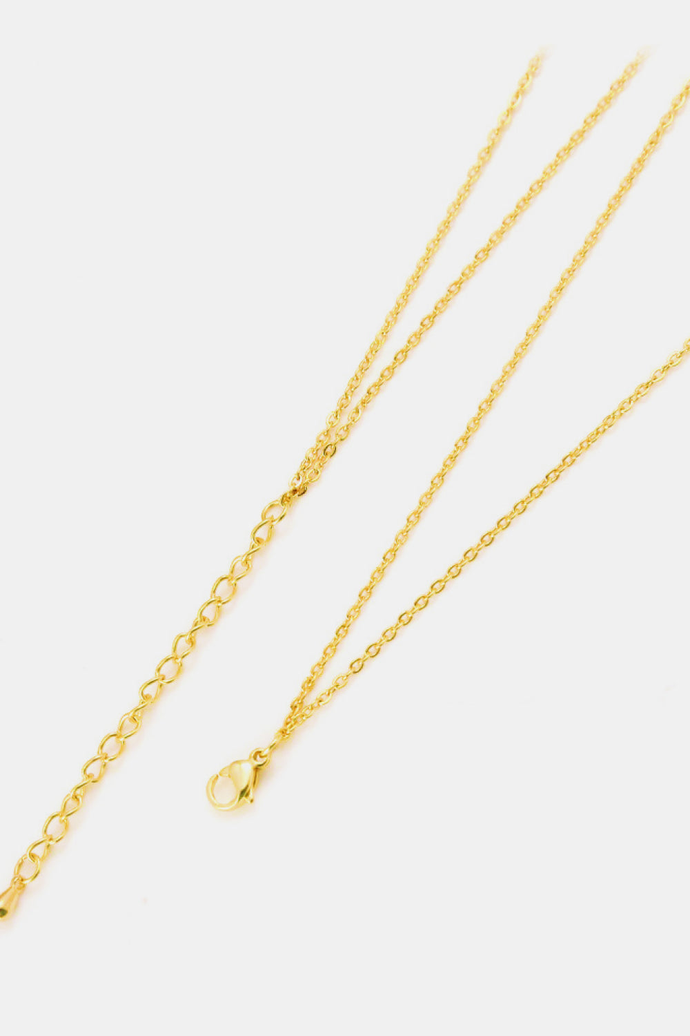 The Linked Ring Pendant Chain Necklace showcases an elegant design with a gold pendant featuring two interlocking circles.