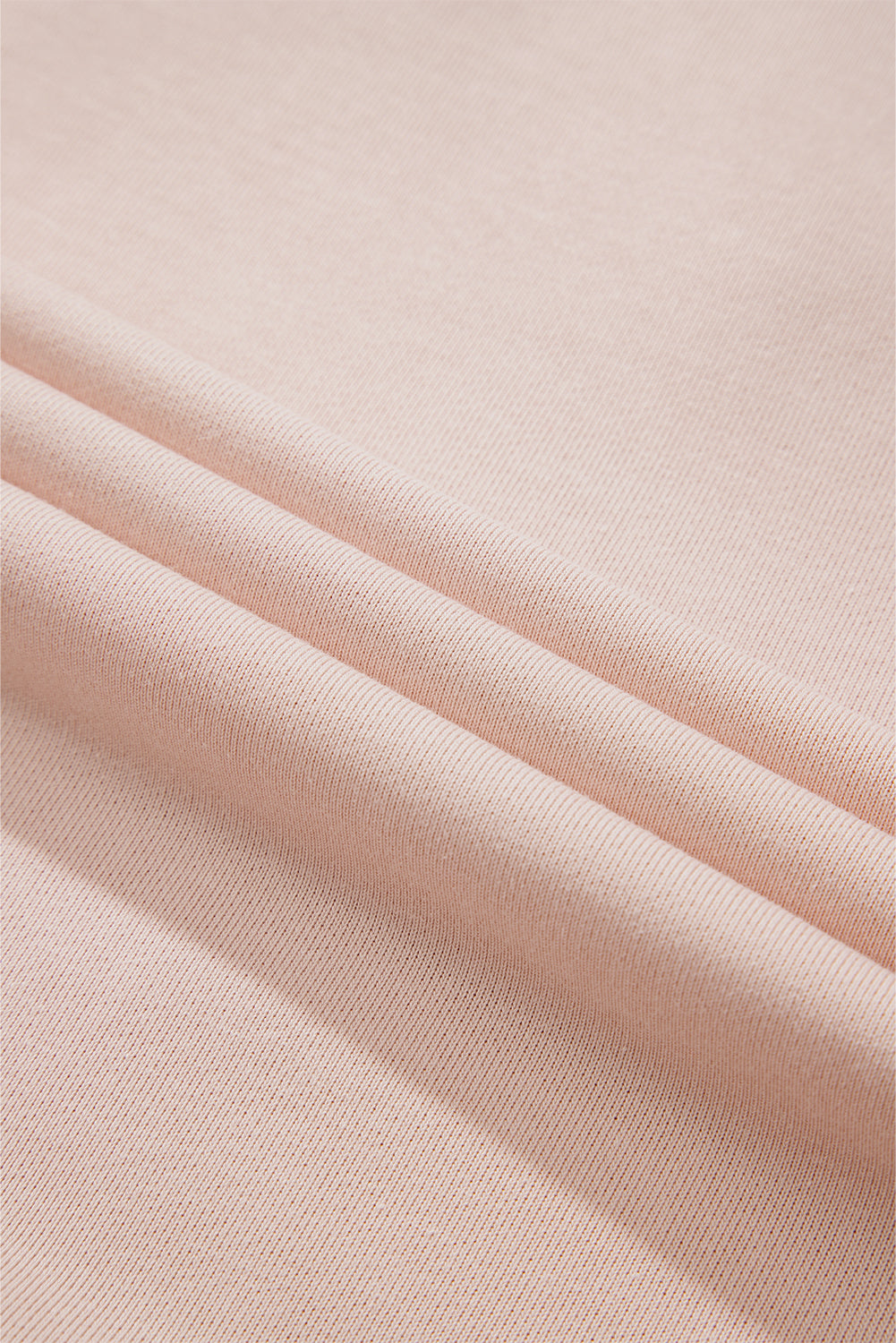 Person wearing the Delicacy Floral Patchwork Star Pattern Drawstring Hoodie, showcasing the floral patchwork design on the hood and sleeves from the back.