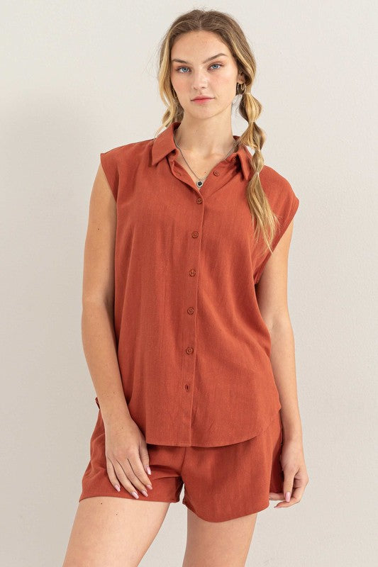 Against a beige backdrop, a woman effortlessly embodies summer style in the Linen Shirt and Shorts Set, featuring a relaxed fit that exudes chic simplicity.