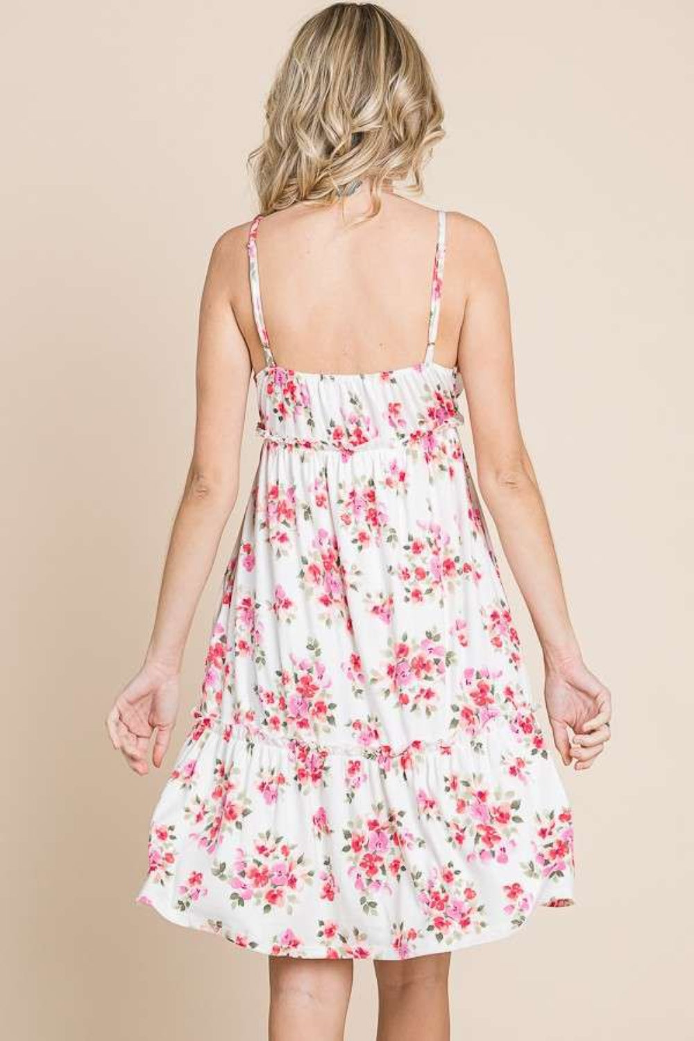 A person wearing the Culture Code Full Size Floral Frill Cami Dress, featuring pink floral patterns, stands against a plain background.