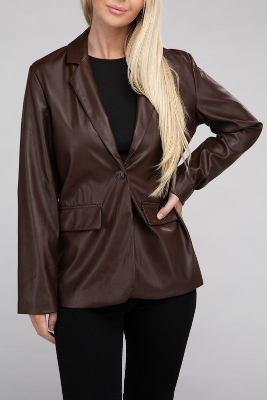 A person with long blonde hair wears the Sleek Pu Leather Blazer with Front Closure over a black top, standing against a plain background.