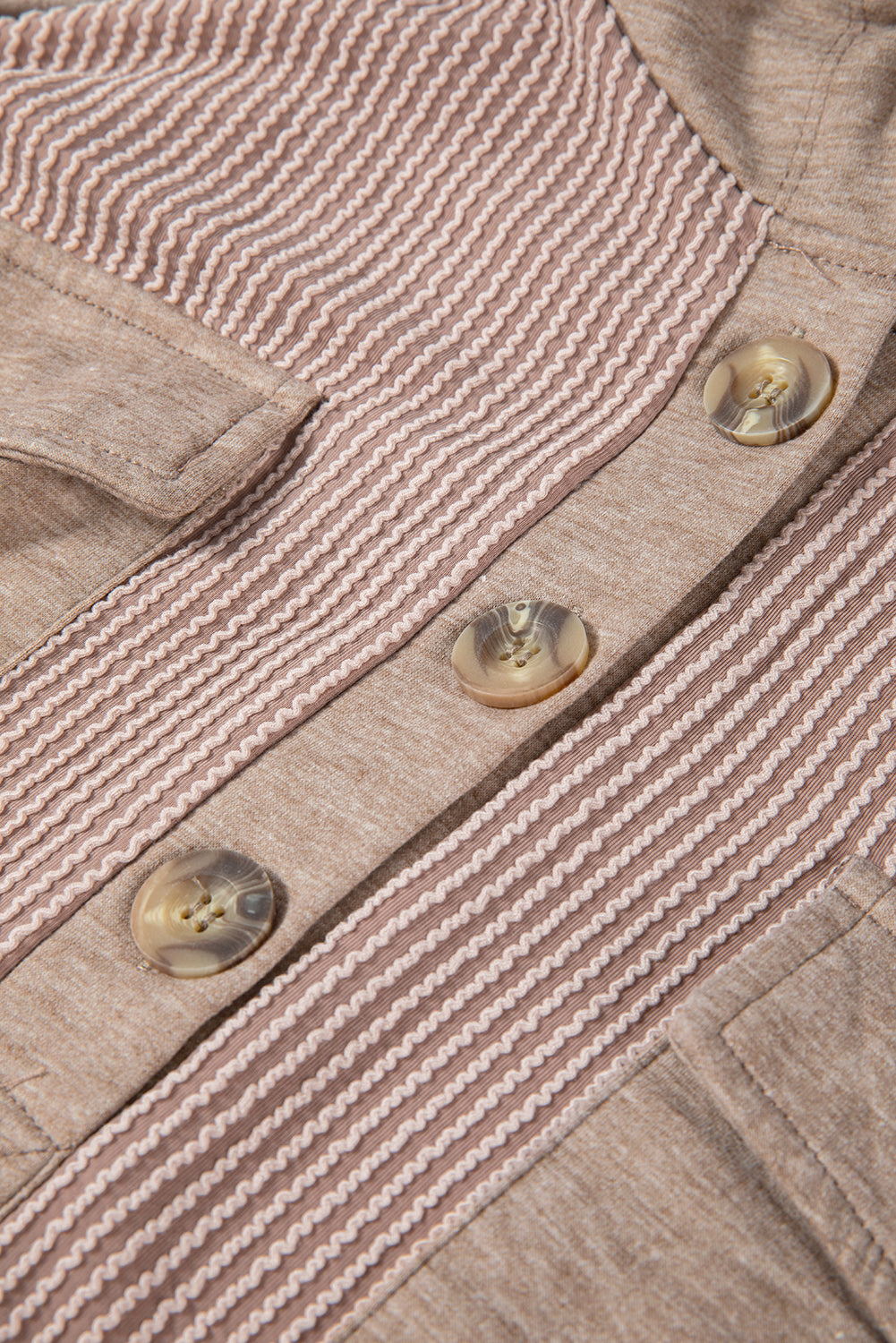 A person with long, wavy hair is facing away from the camera. They are wearing a Dark Brown Flap Pocket Patchwork Corded Drawstring Hoodie and blue jeans, holding a brown shoulder bag.