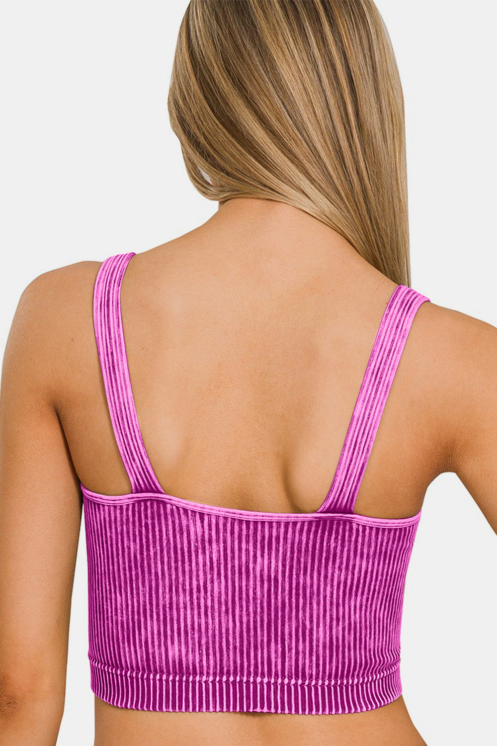 A woman with long blonde hair wears a Zenana Washed Ribbed Cropped V-Neck Tank in pink and white stripes, smiling slightly against a plain background.