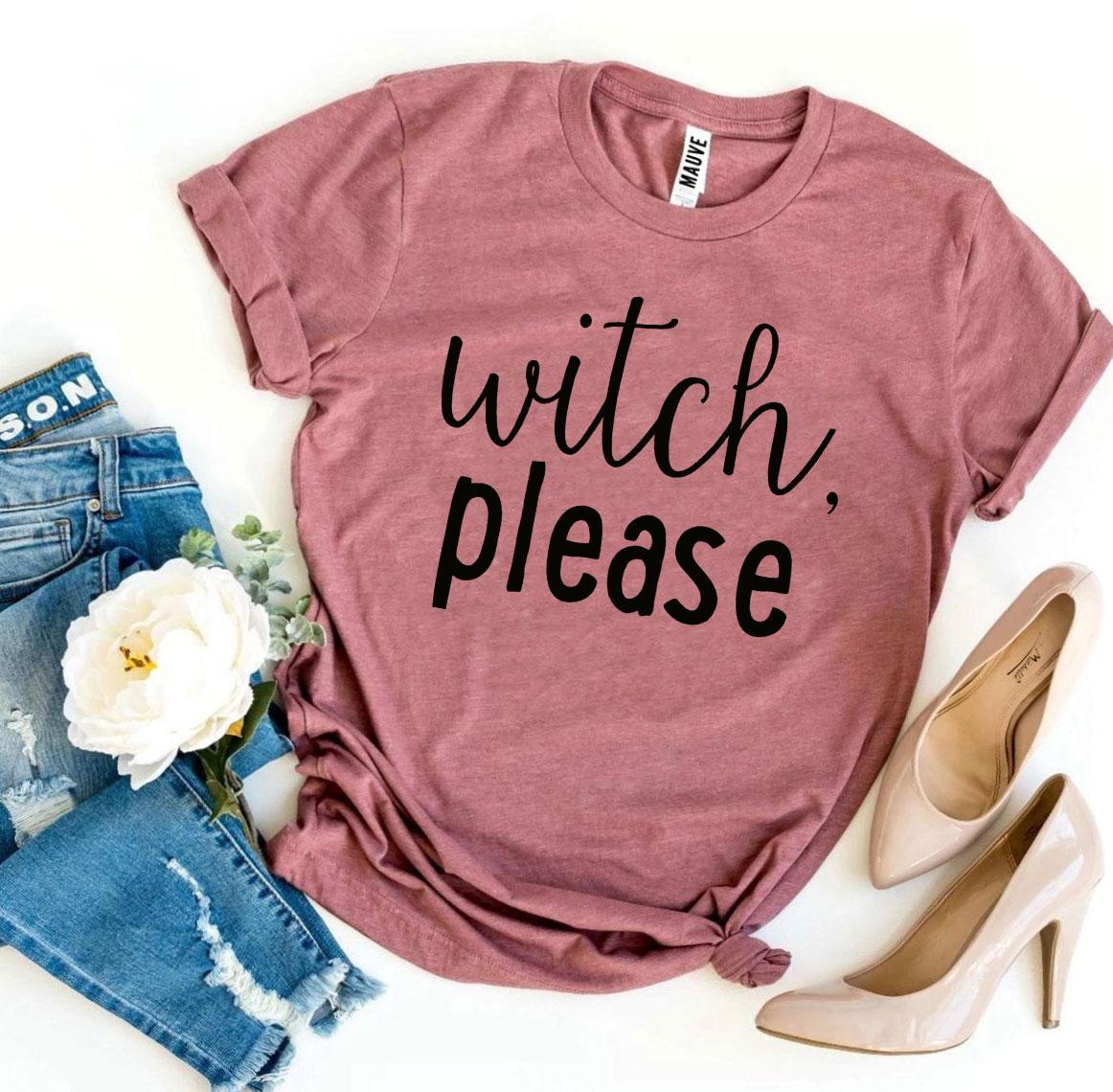 A Witch Please T-shirt in gray, celebrated for its soft texture and comfortable retail fit, is beautifully laid out next to a pair of blue jeans, beige high heels, and a bouquet of flowers.