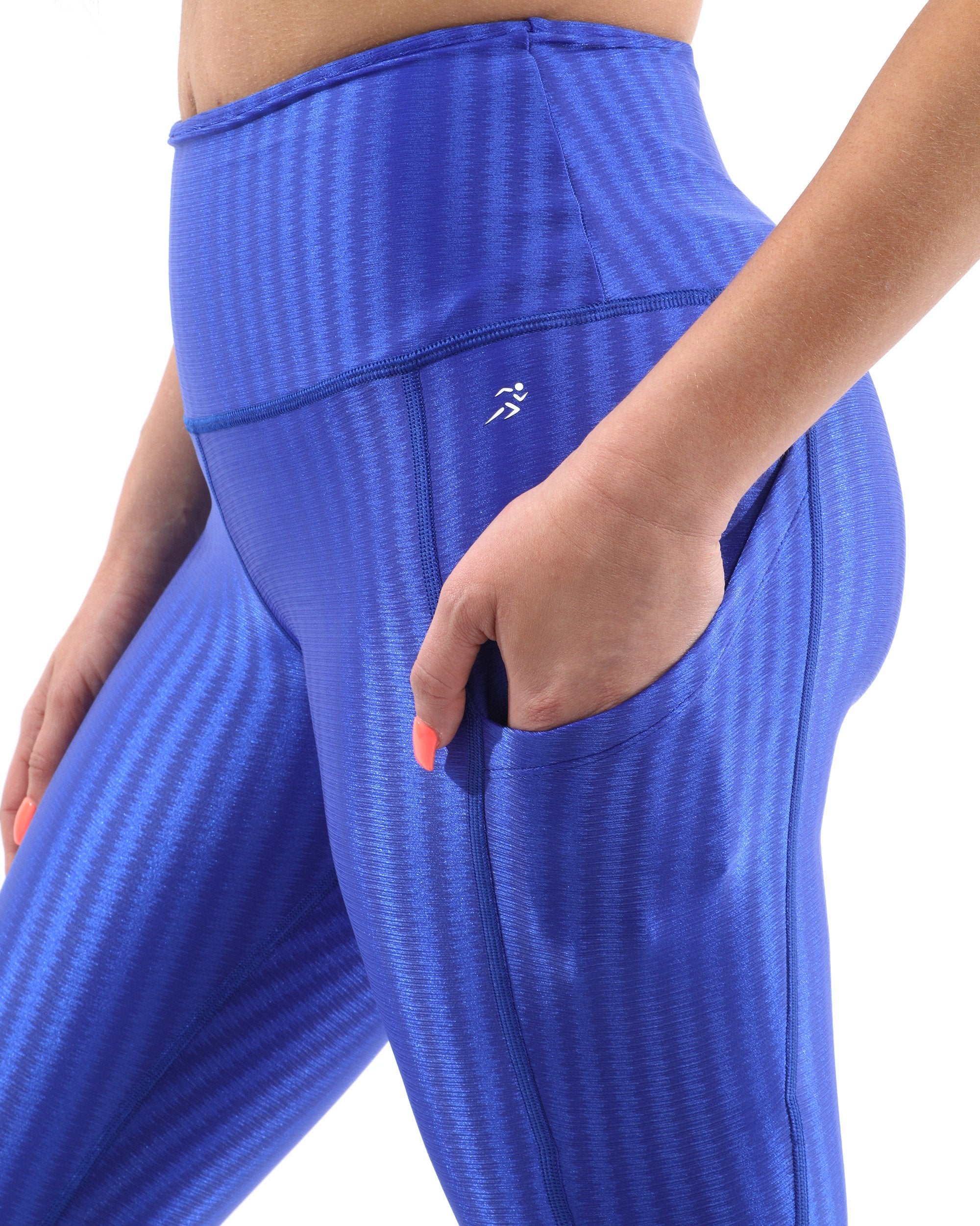 A person wearing SALE! 50% OFF! Firenze Activewear Leggings - Blue [MADE IN ITALY] and black shoes is standing with hands resting on hips. The sculpted fit leggings highlight the torso and legs, but the head remains out of view.