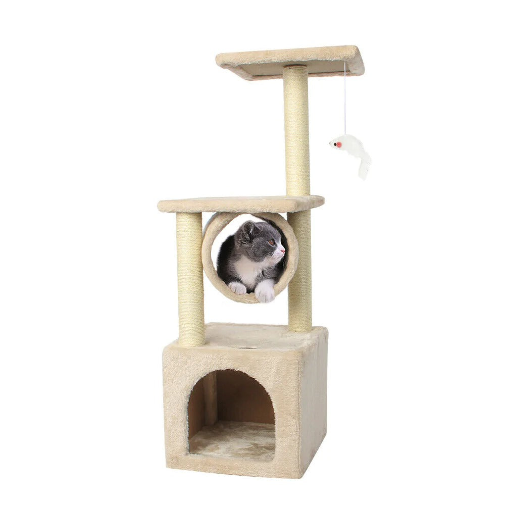 A cat inside the cubby of a Cat Tree House Tower, with a toy fish hanging nearby.