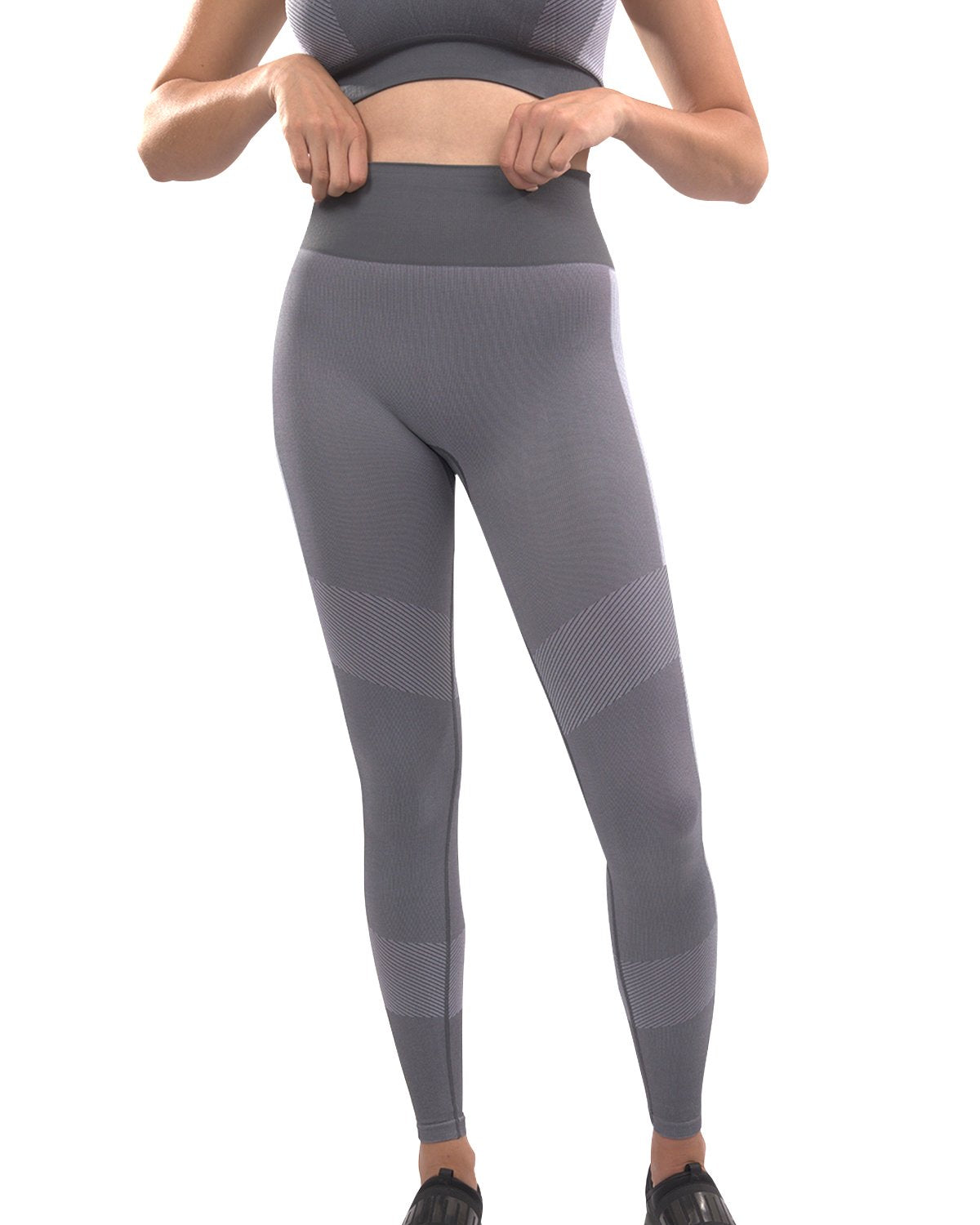 A person wearing high-waisted Arleta Seamless Leggings in grey, featuring geometric patterns, is shown from the back against a white background.