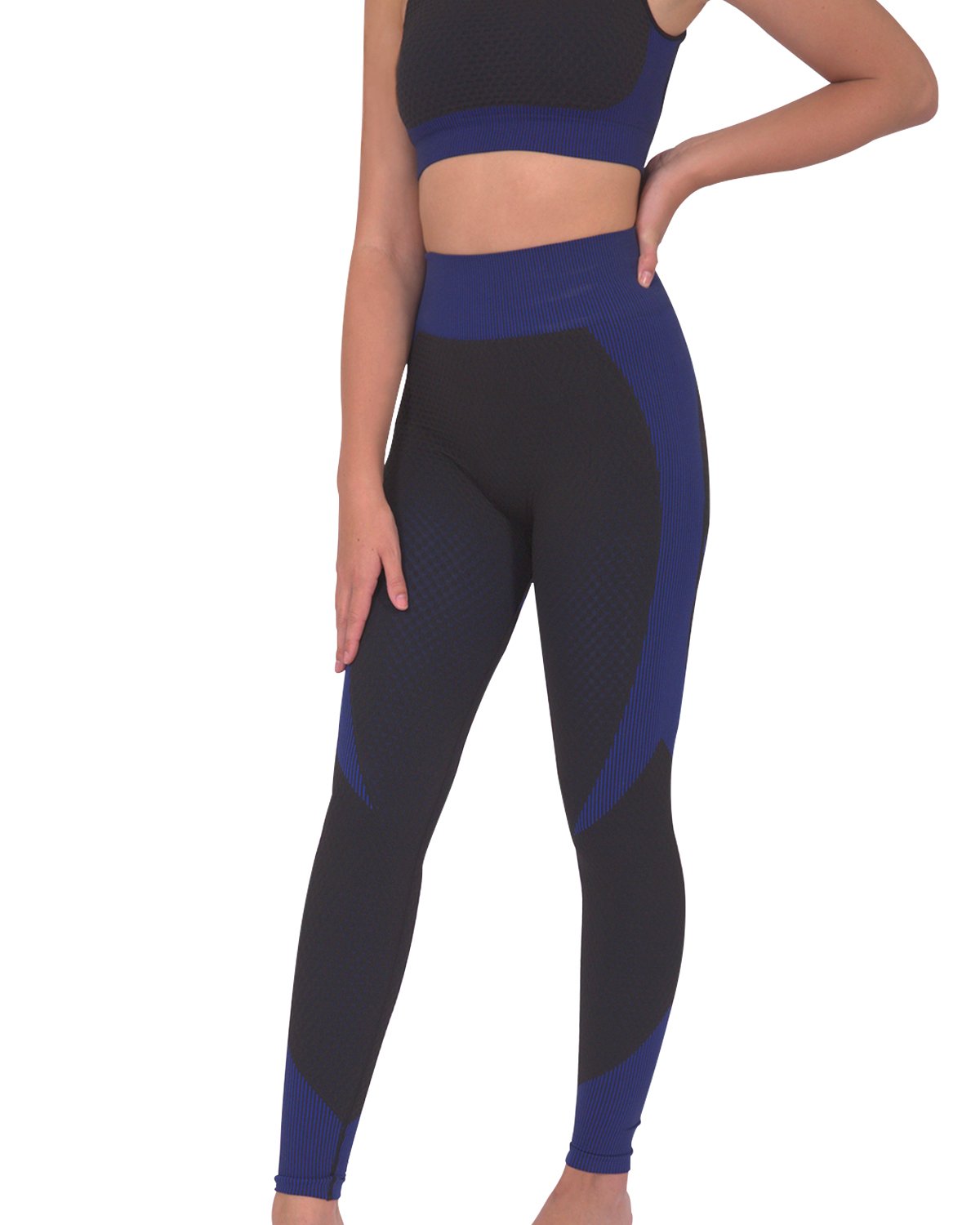 Person in a workout outfit showcasing the back view of Trois Seamless Legging - Black with Navy and a matching sports bra against a white background, highlighting the high-compression bodycon fabric.