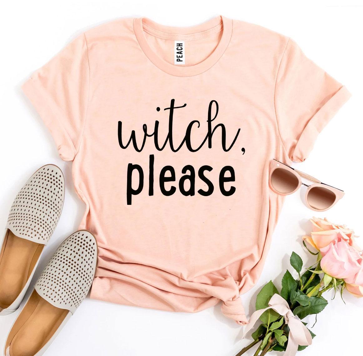 A Witch Please T-shirt in gray, celebrated for its soft texture and comfortable retail fit, is beautifully laid out next to a pair of blue jeans, beige high heels, and a bouquet of flowers.