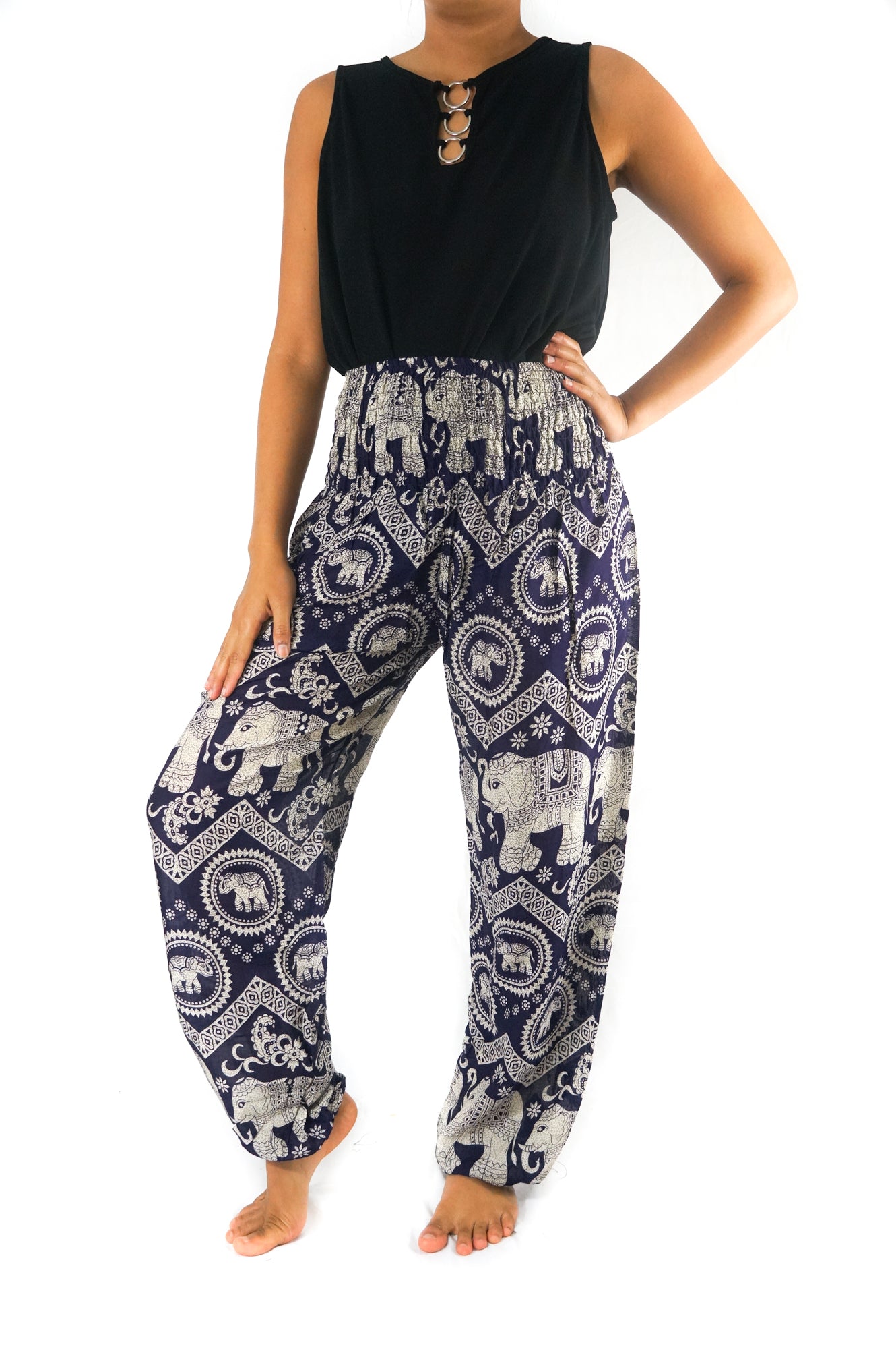 Two views of a person wearing the Purple ELEPHANT Pants: Women Boho Pants Hippie Pants Yoga, showcasing the intricate purple and white elephant patterns. Front and back views are provided to highlight the elastic waist and 100% rayon fabric.