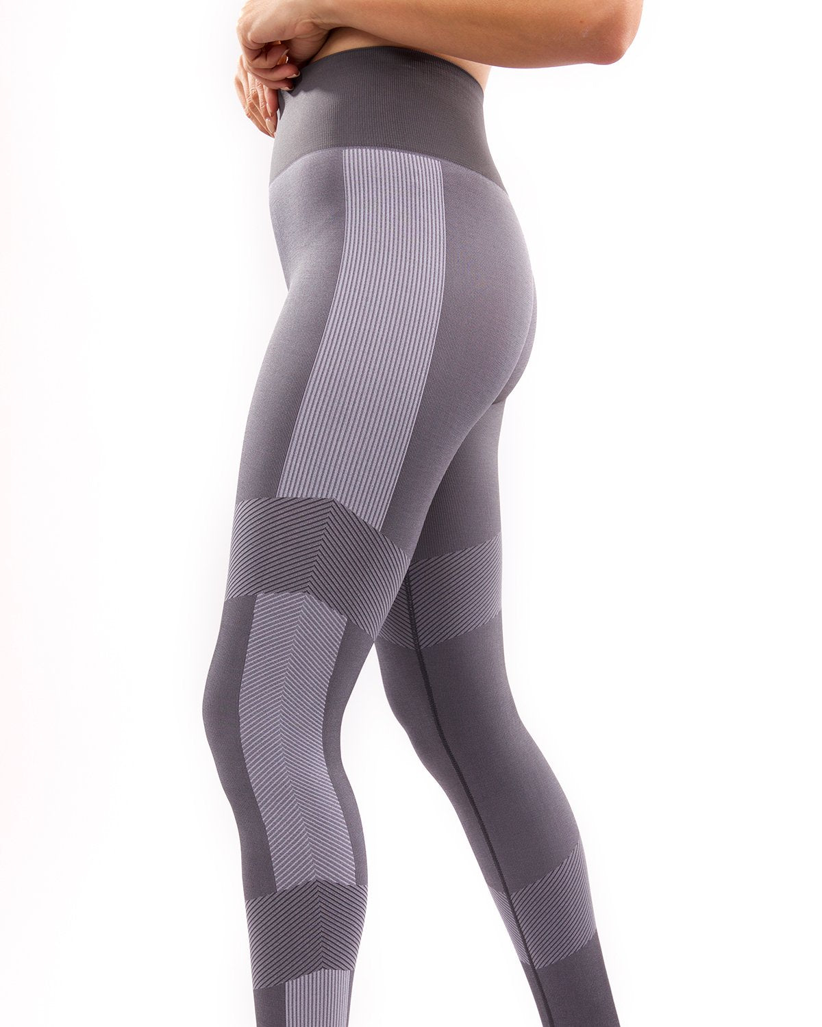 A person wearing high-waisted Arleta Seamless Leggings in grey, featuring geometric patterns, is shown from the back against a white background.