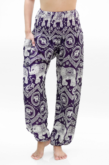 Two views of a person wearing the Purple ELEPHANT Pants: Women Boho Pants Hippie Pants Yoga, showcasing the intricate purple and white elephant patterns. Front and back views are provided to highlight the elastic waist and 100% rayon fabric.