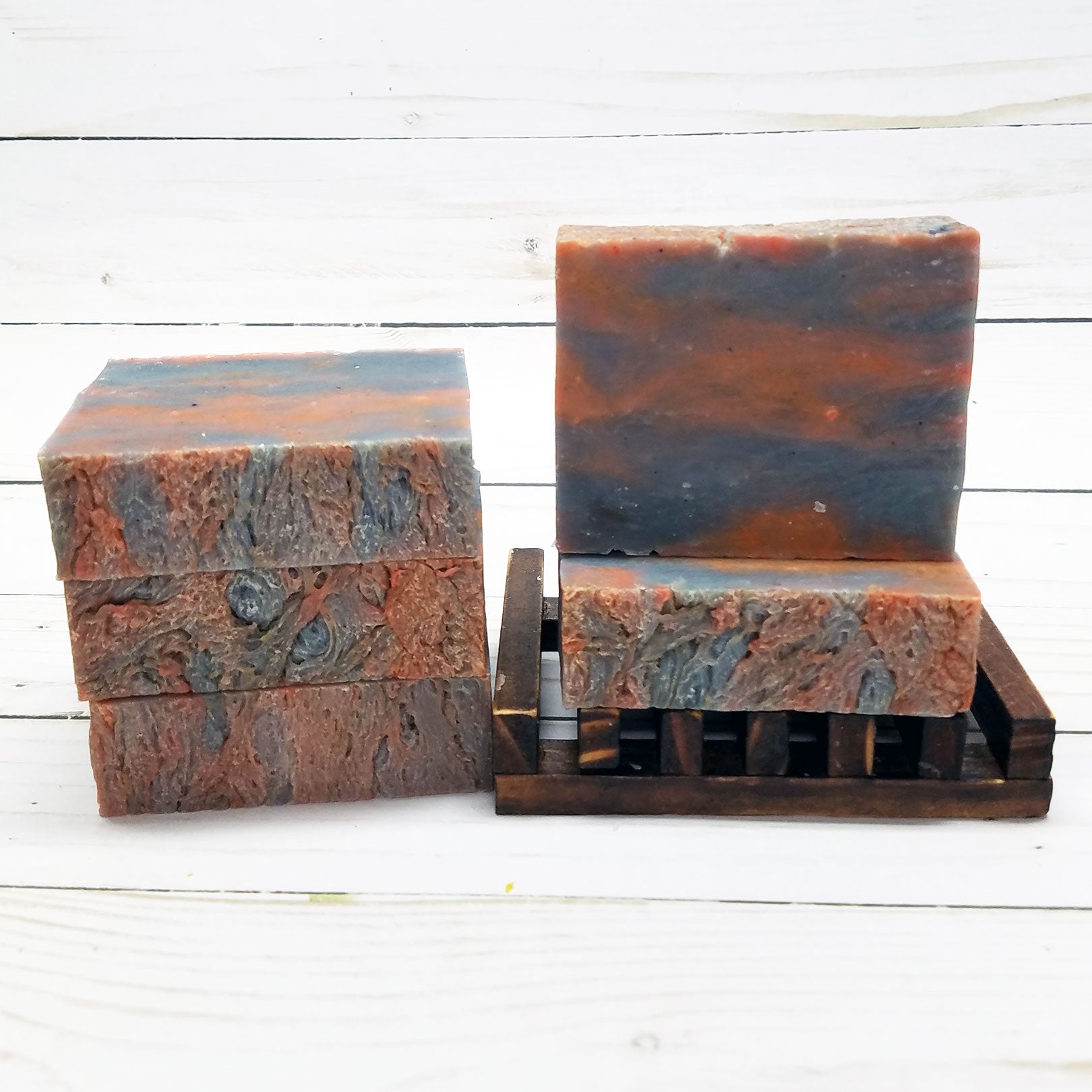 The "Lakeside Fire Handmade Soap" from Buck Ridge Soap Company features a deer logo and highlights its "Handmade in USA," "100% Vegan," and "All Natural" qualities. This luxurious soap is part of our natural skin care line and has a net weight of 4 oz.