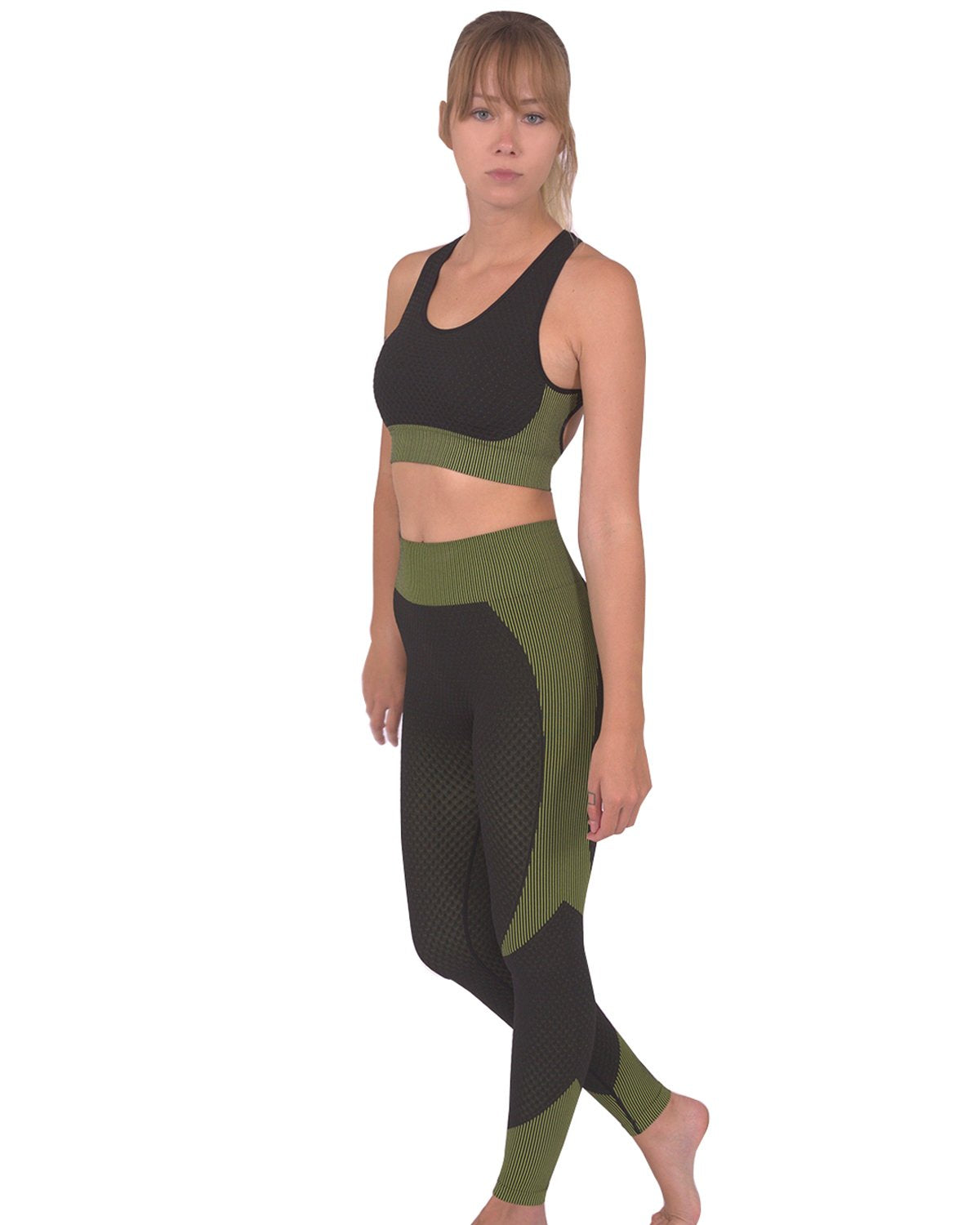 A person is dressed in a green and black athletic outfit, featuring the Trois Two Set. This set includes a sleeveless top paired with high-waisted Trois Seamless Legging - Black with Green, made from high-compression bodycon fabric with a textured pattern. The person's face is not visible in the image.