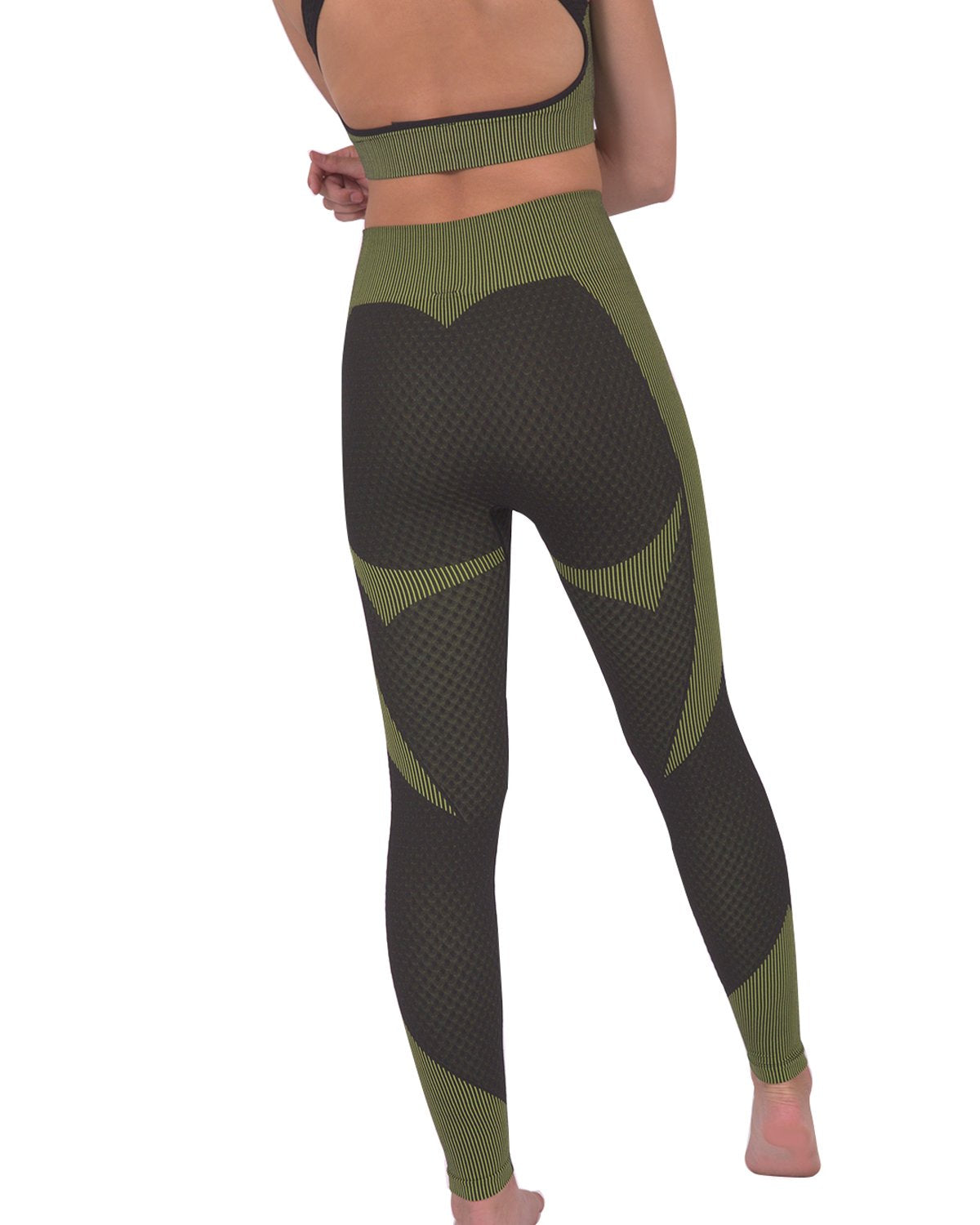 A person is dressed in a green and black athletic outfit, featuring the Trois Two Set. This set includes a sleeveless top paired with high-waisted Trois Seamless Legging - Black with Green, made from high-compression bodycon fabric with a textured pattern. The person's face is not visible in the image.