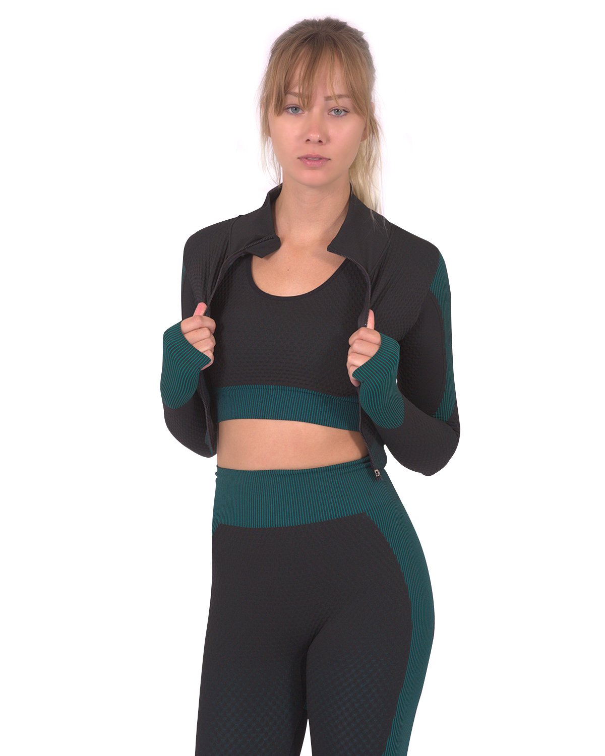 A woman wearing the Trois Seamless Sports Jacket - Black with Blue and leggings with fabric designs.