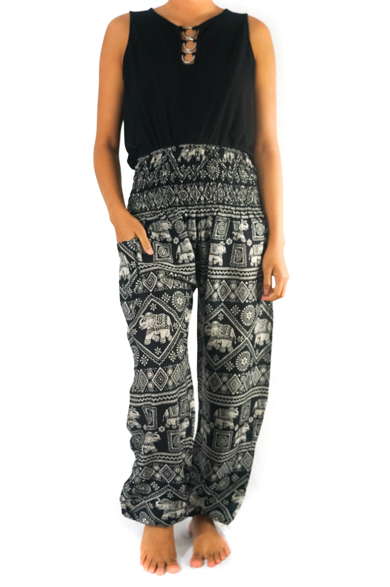 Person wearing Black ELEPHANT Pants Women Boho Pants Hippie Pants Yoga, featuring an elastic waist and black and white elephant pattern, shown in two poses.