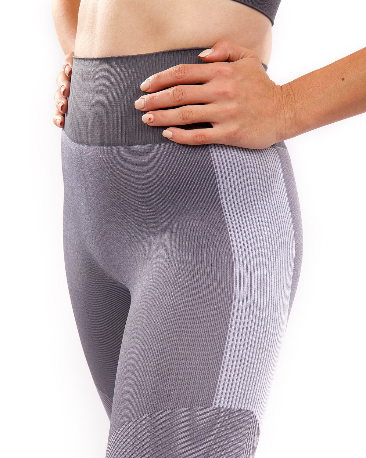 A person wearing high-waisted Arleta Seamless Leggings in grey, featuring geometric patterns, is shown from the back against a white background.