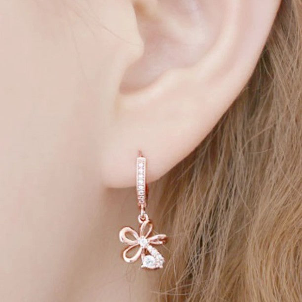 Gemma Floral Crystal Earrings with 14K Gold Pin with a bow design, embellished with small cubic zirconia.