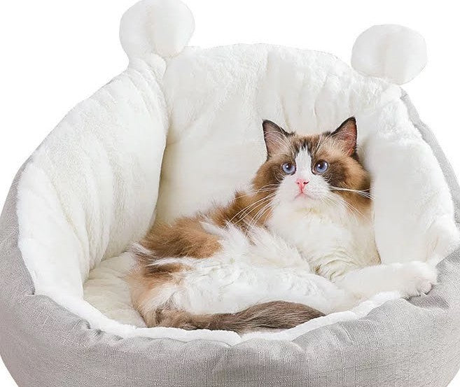 A soft and comfy cat is laying in a CAT BED SLEEPING BAG (Grey-Medium).