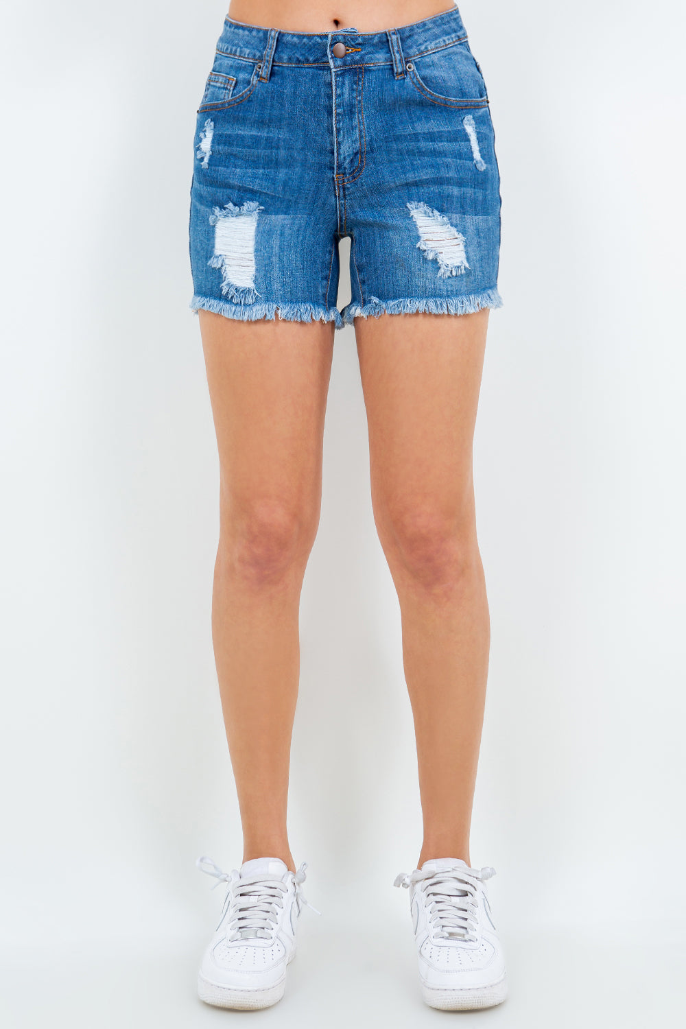 Person wearing American Bazi High Waist Distressed Frayed Denim Shorts and white sneakers, standing in front of a plain background—perfect for any summer wardrobe.