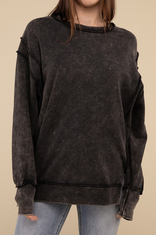 Woman in an Acid Wash French Terry Exposed-Seam sweatshirt standing against a beige background.