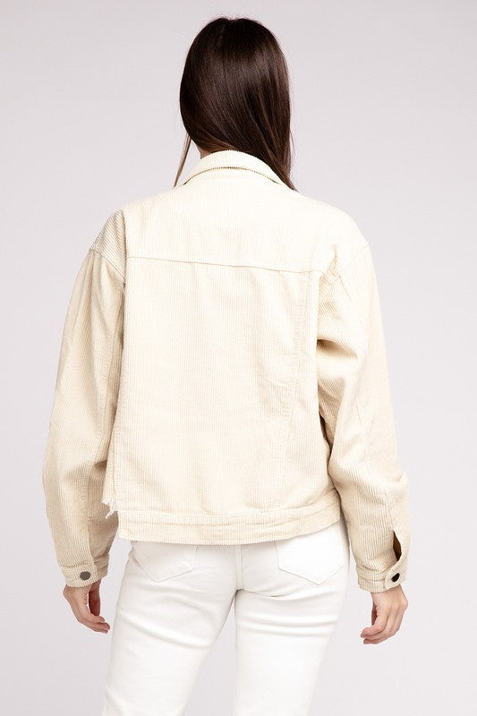 Woman wearing an oversized ribbed shacket with long sleeves and front pockets, exuding cozy comfort against a plain background.