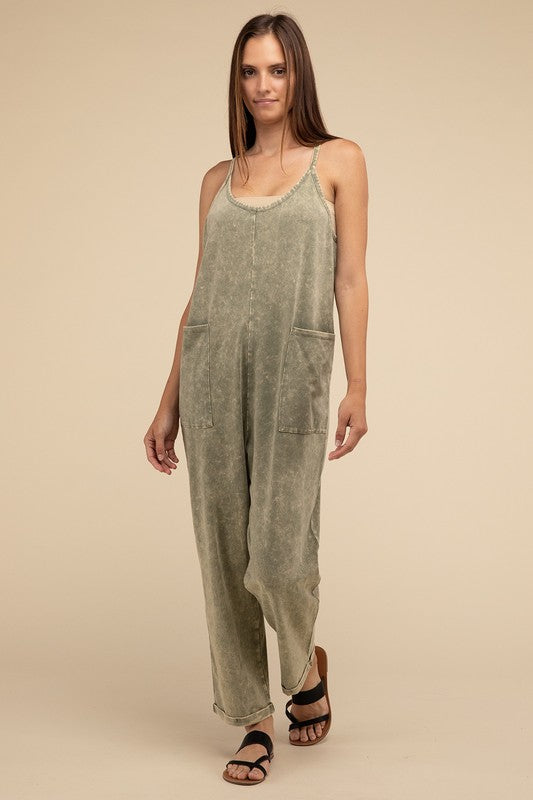 Woman standing and posing in a studio, wearing casual comfort style green Washed Spaghetti Straps Overalls with Pockets and sandals.