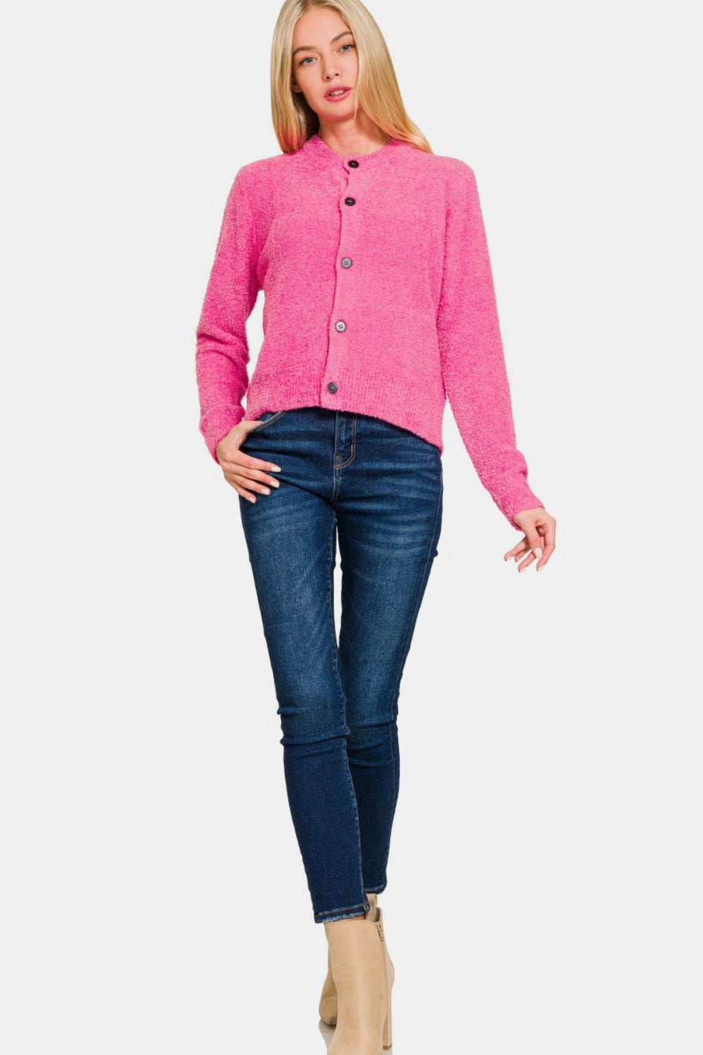 A person with long blonde hair wears a Zenana Button Down Long Sleeve Sweater Cardigan in bright pink and dark blue jeans, posing against a plain white background.