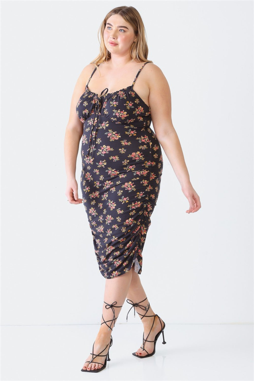 A woman stands against a white background wearing a Blue Leopard Plus Size Ruched Floral Square Neck Cami Dress with strappy high-heeled sandals, perfect for a summer day out.