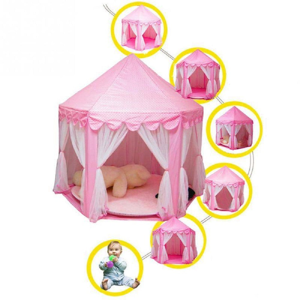 A purple children's Outdoor Indoor Portable Folding Princess Castle Tent Kids Children Funny Play Fairy House Kids Play Tent(LED Star Lights) illuminated by fairy lights at night, set up outdoors near a building.