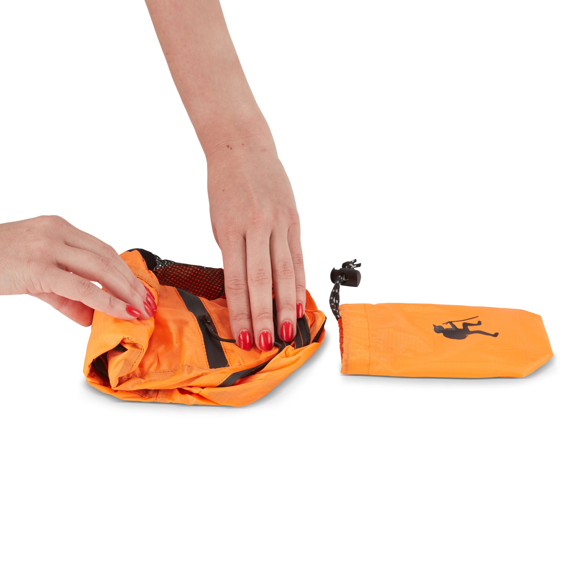 A hand holding a small, black HIKE Back- Folding Backpack with a white hiker icon printed on it, isolated against a white background.