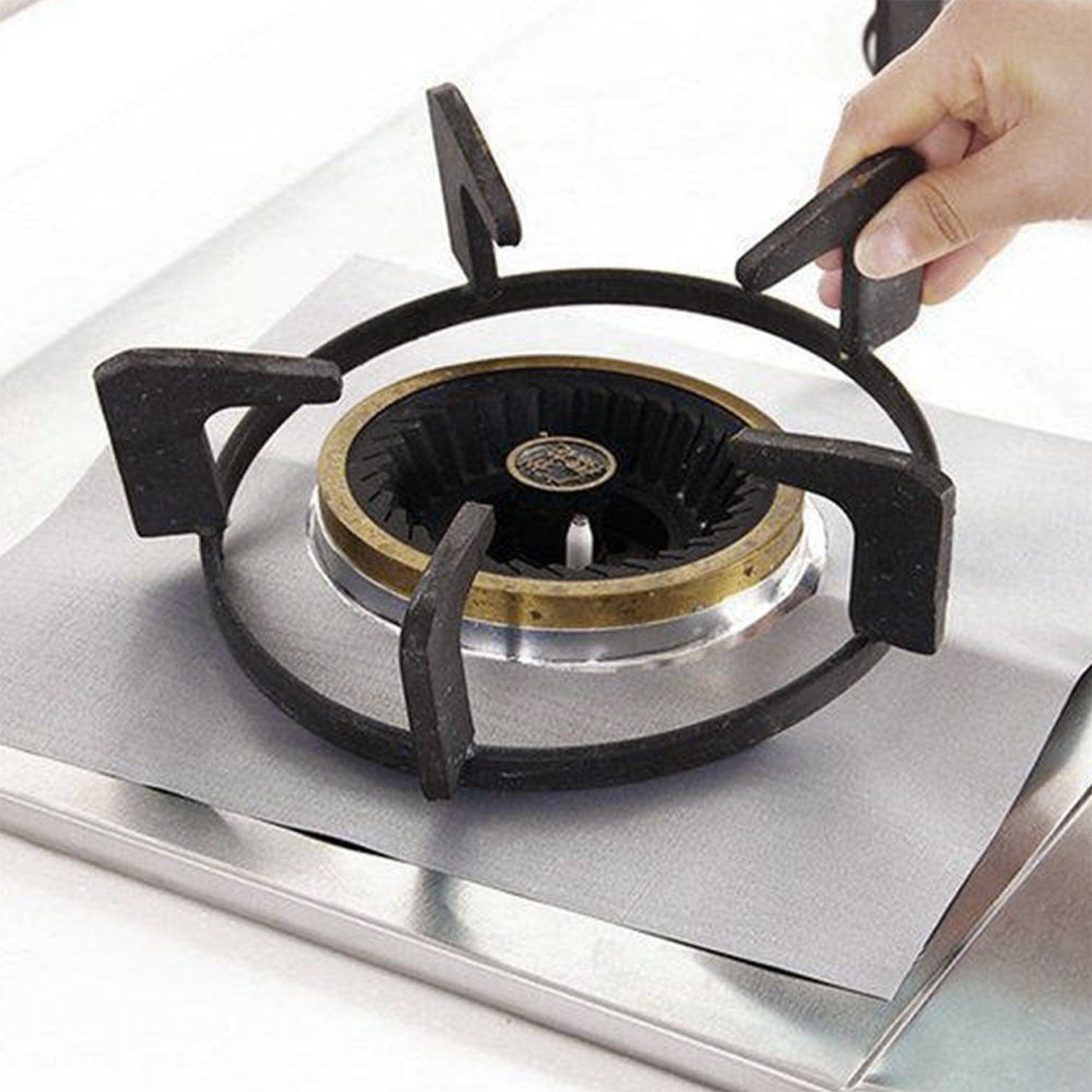 A stack of 4-Pack Reusable Nonstick Stovetop Burner Protector Liner papers with a white circle and crossing lines symbol in the center of the top sheet, treated with a PTFE coating.
