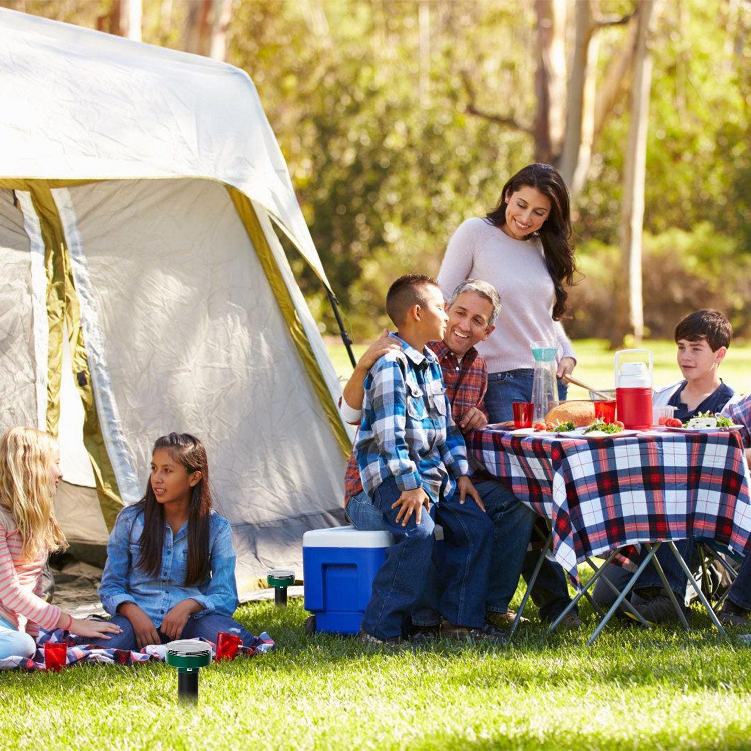 Four 4Pcs Solar Powered Mole Repeller Sonic Gopher Stakes inserted in the ground with icons emphasizing their features like waterproof protection and safety, beside a girl and a chicken in a grassy yard.