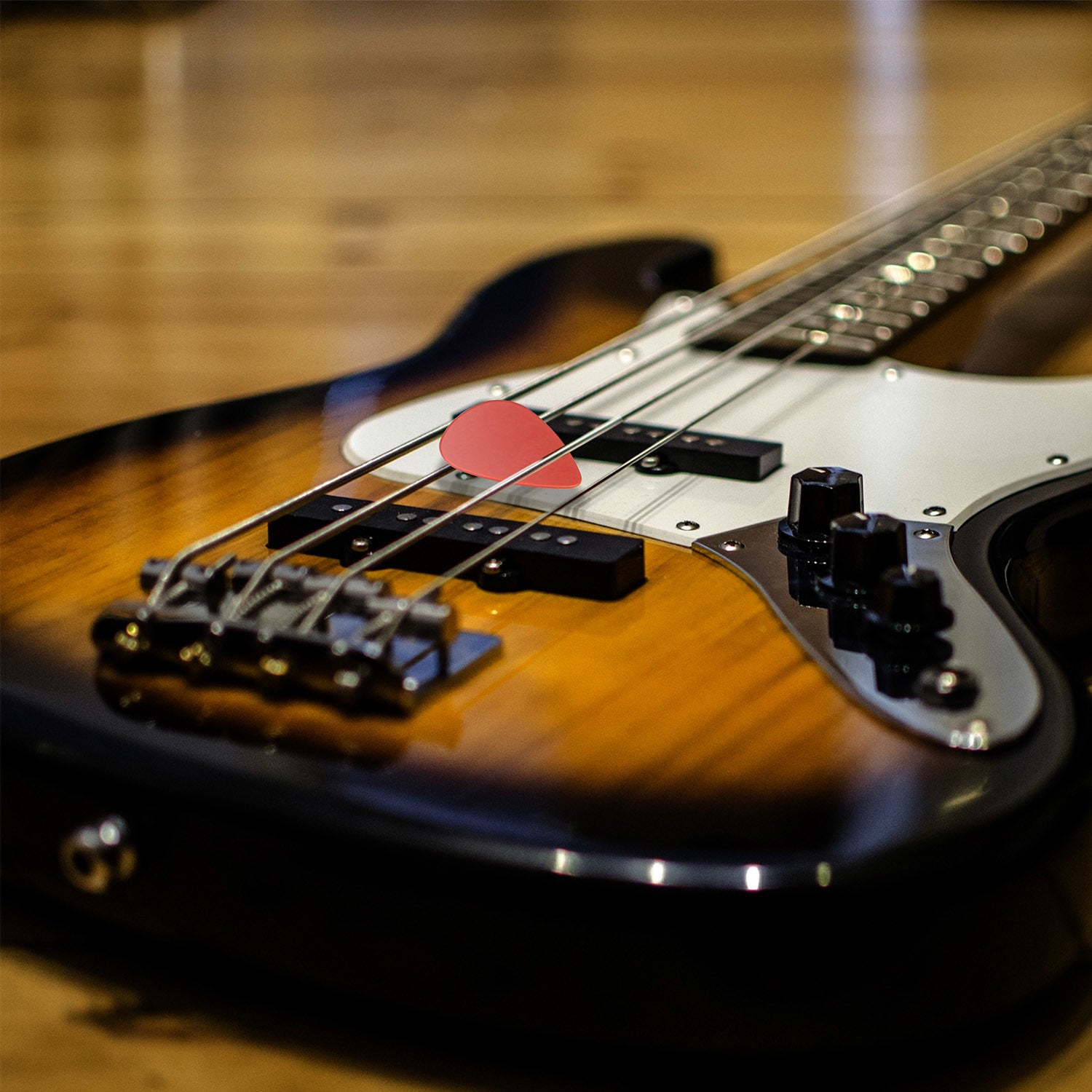 A circular arrangement of Standard Acoustic Electric Plectrums Guitar Picks 12-Pack in red, purple, green, yellow, and blue, creating a symmetrical pattern on a white background.