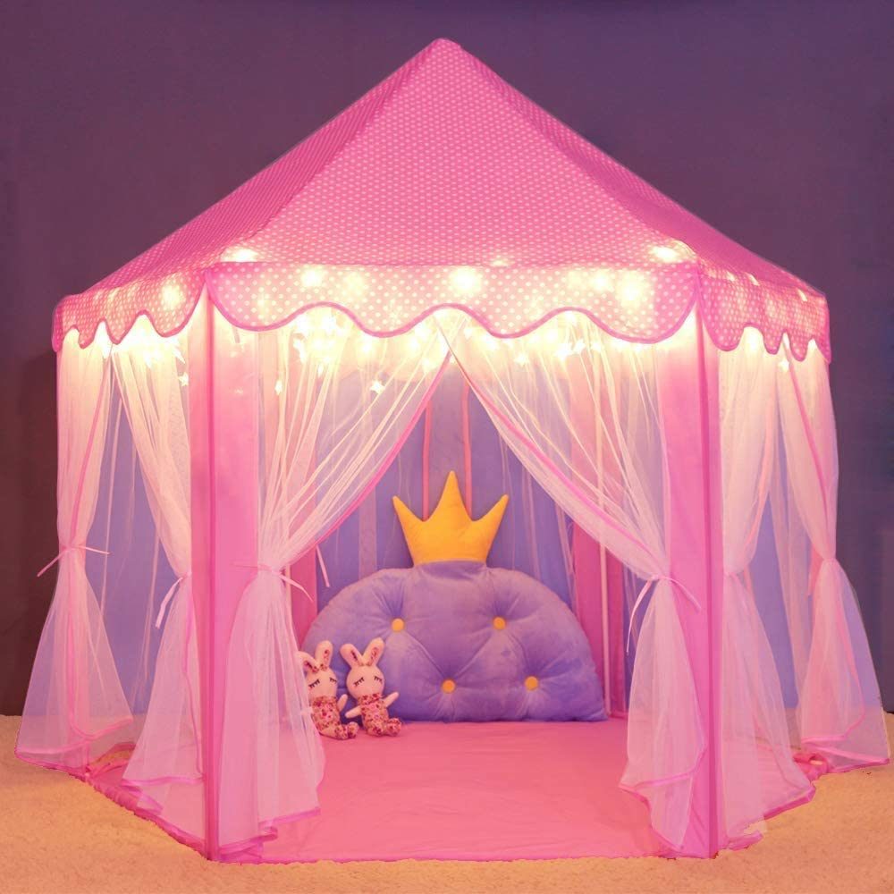 A pink Outdoor Indoor Portable Folding Princess Castle Tent Kids Children Funny Play Fairy House Kids Play Tent with its flap open, displaying several teddy bears inside, illuminated by string lights, with a star-shaped light visible at the top corner.