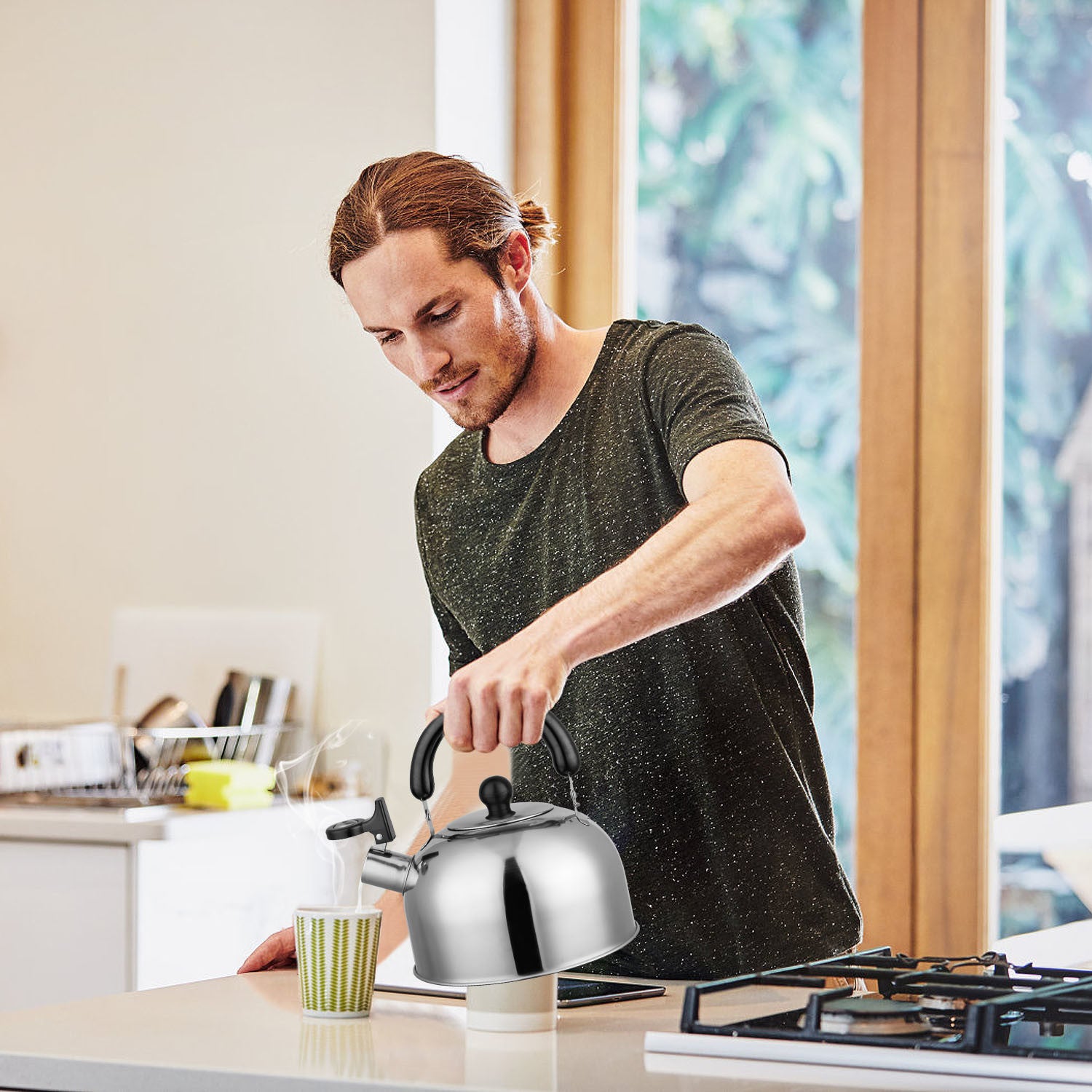 2.1Quarts Stainless Steel Whistling Tea Kettle Stovetop Induction Gas Teapot with Insulated Handle Camping Kitchen Office with a black handle and spout, featuring a loud whistling sound, isolated on a white background.