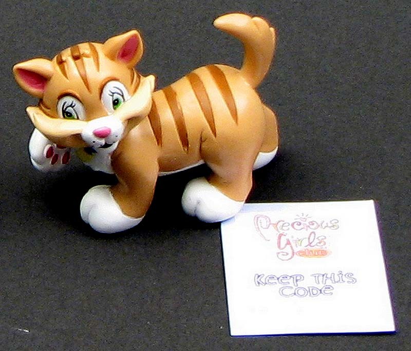 Sentence with Product Name: Toy tiger with stripes and white paws next to a Precious Girls Club Toppit Cat Figure rainbow membership card that reads "KEEP THIS CODE.