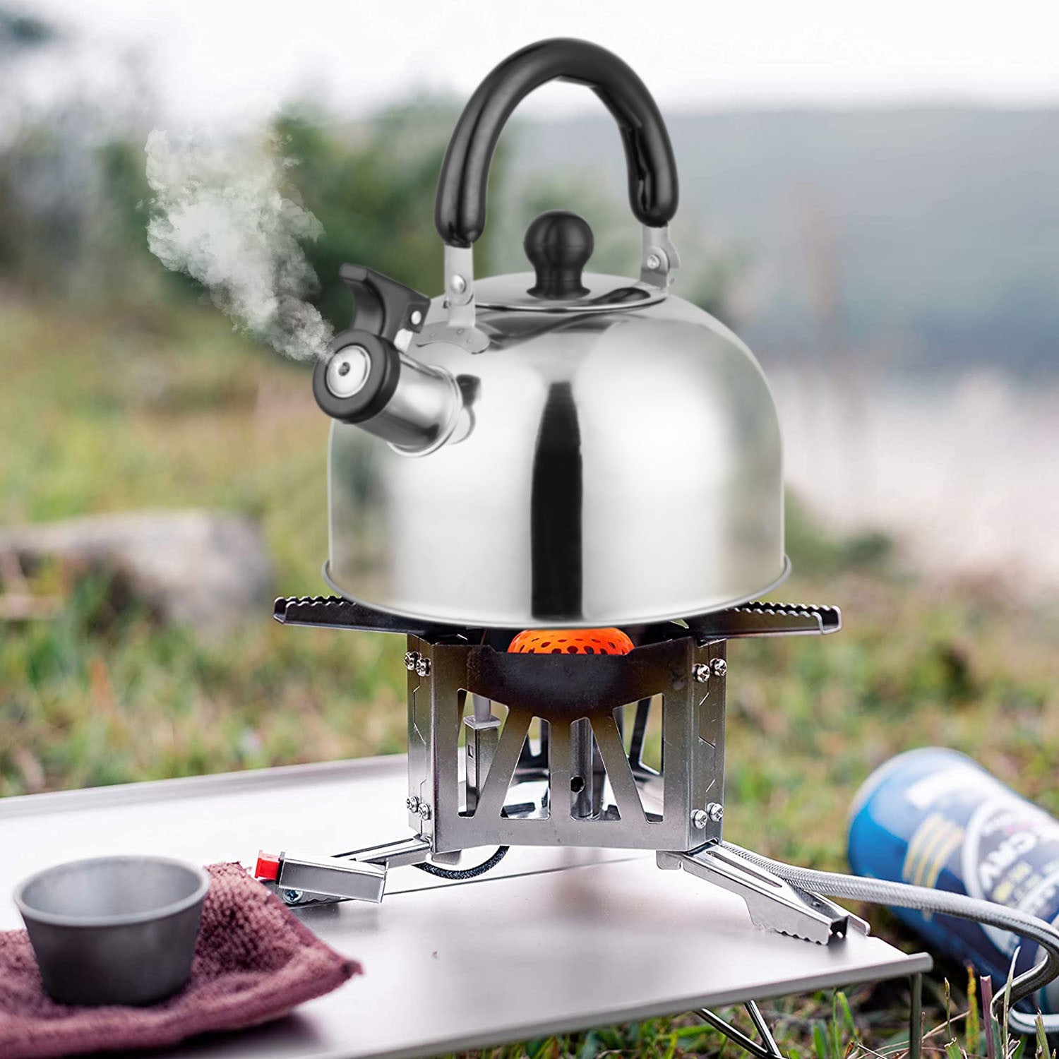 2.1Quarts Stainless Steel Whistling Tea Kettle Stovetop Induction Gas Teapot with Insulated Handle Camping Kitchen Office with a black handle and spout, featuring a loud whistling sound, isolated on a white background.