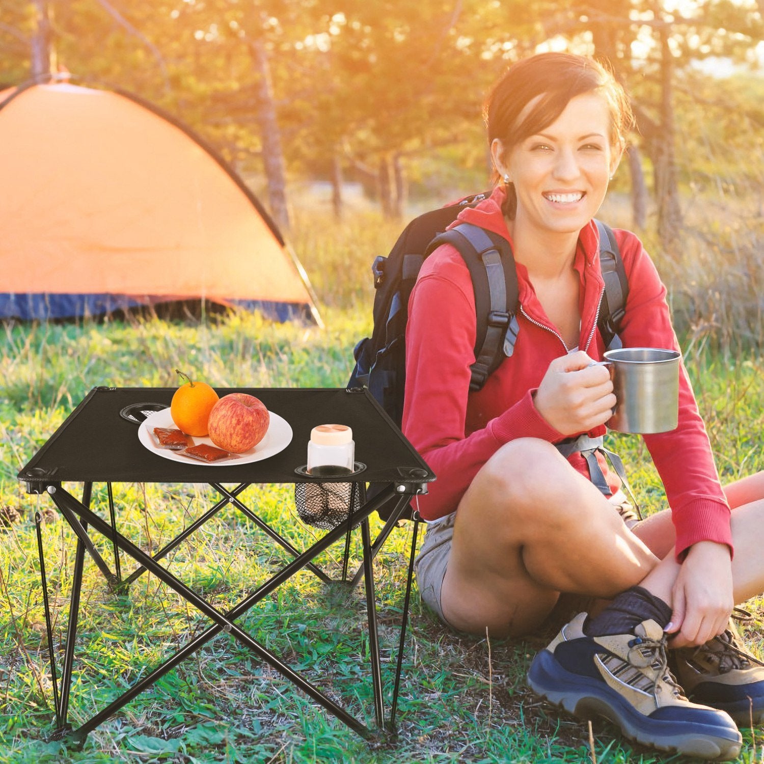 Portable black camping chair with two cup holders, made from sturdy 600D Oxford fabric, shown both set up and folded inside a carry bag.