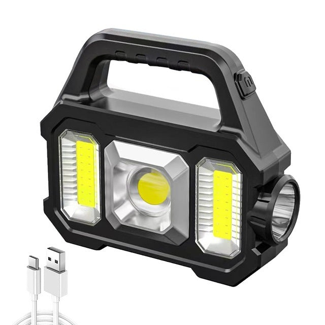 A hand holding a 2N1 Solar COB Work Light featuring a central spotlight and two side lights.
