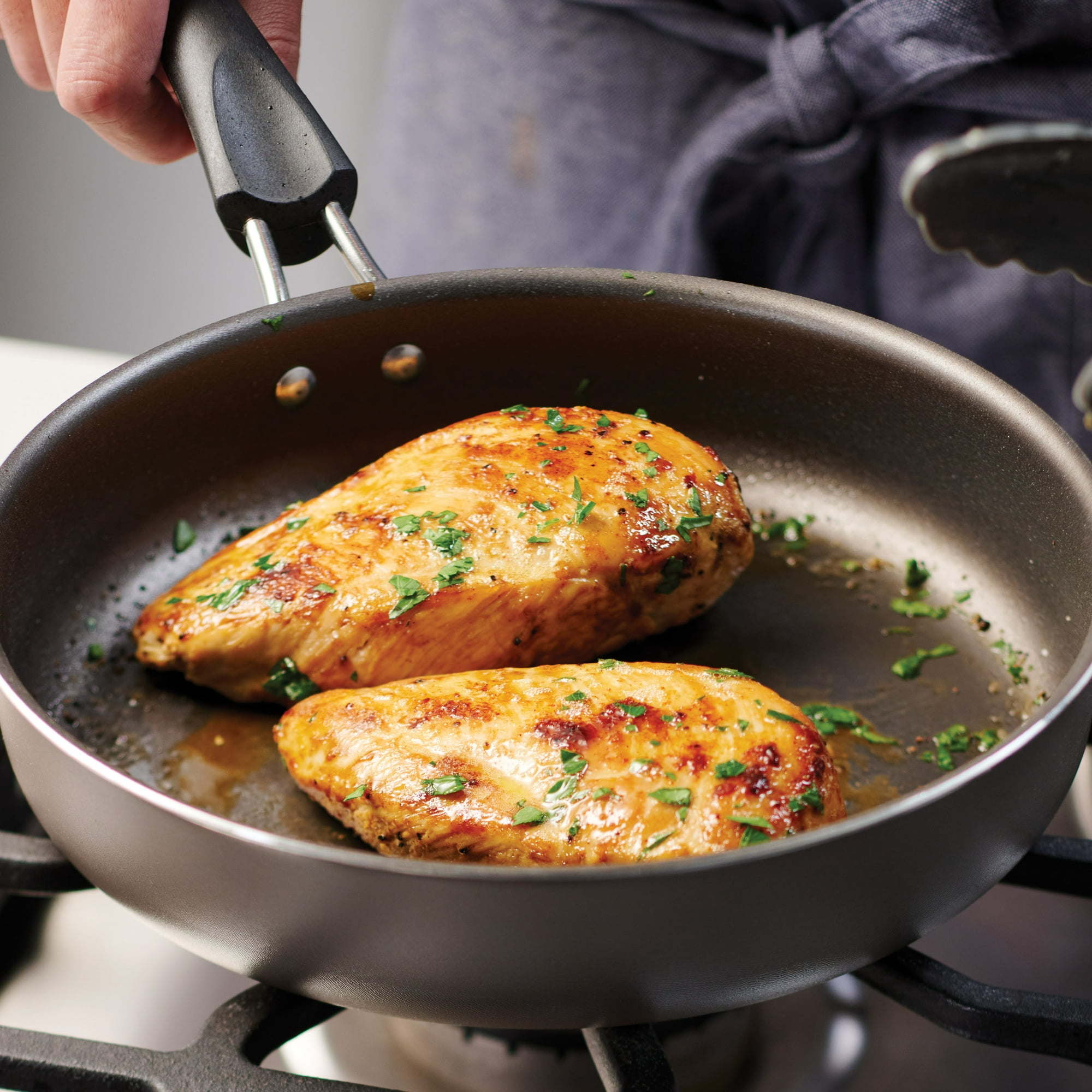A set of new 9-Piece Non-Stick Cookware Set including two pots, a saucepan, and two frying pans, all with tempered glass lids and black handles, arranged on a white background.