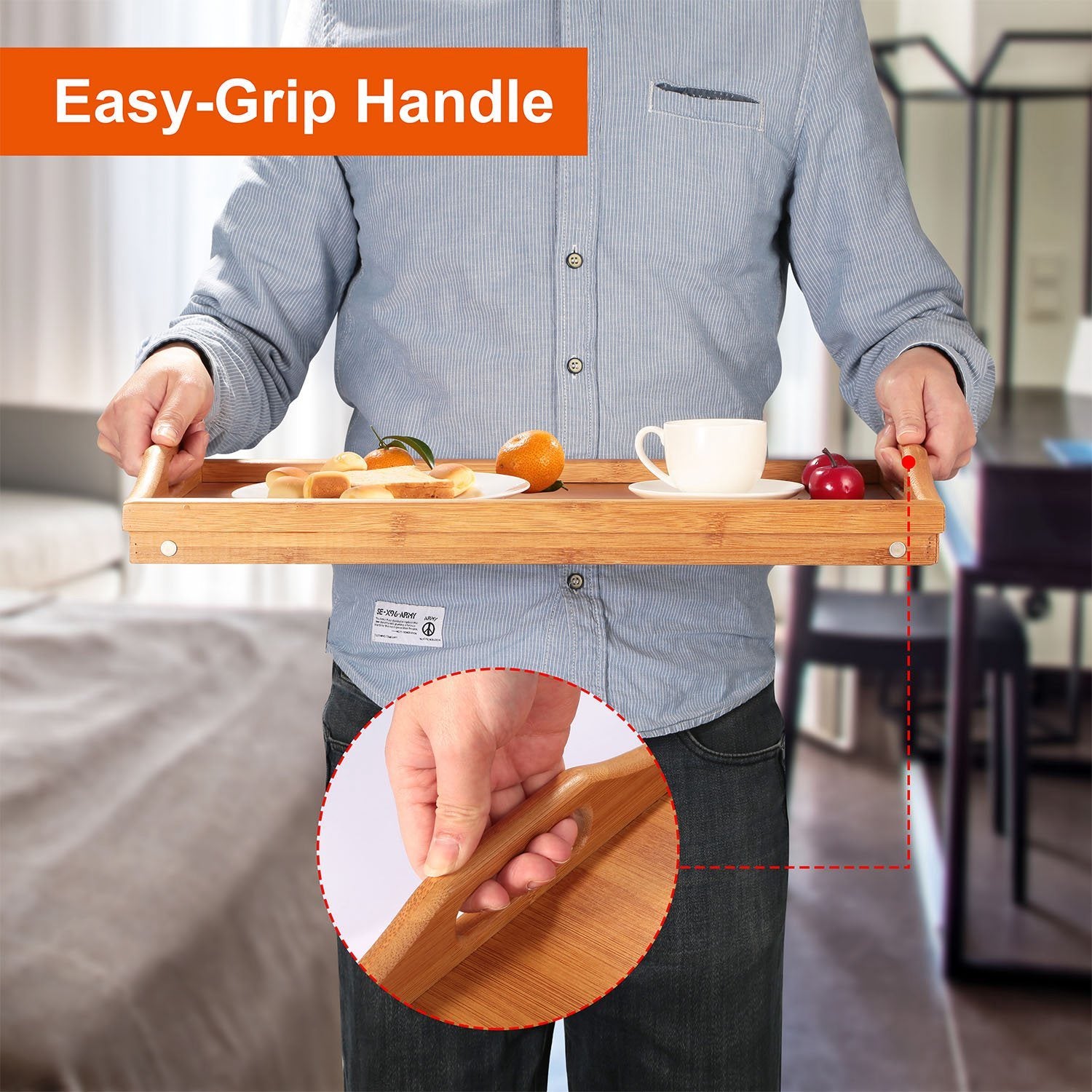 Bamboo Folding Bed Table Breakfast Tray with legs, holding a cup, fruits, a jar of nuts, and a plate with cheese and crackers, on a white background.