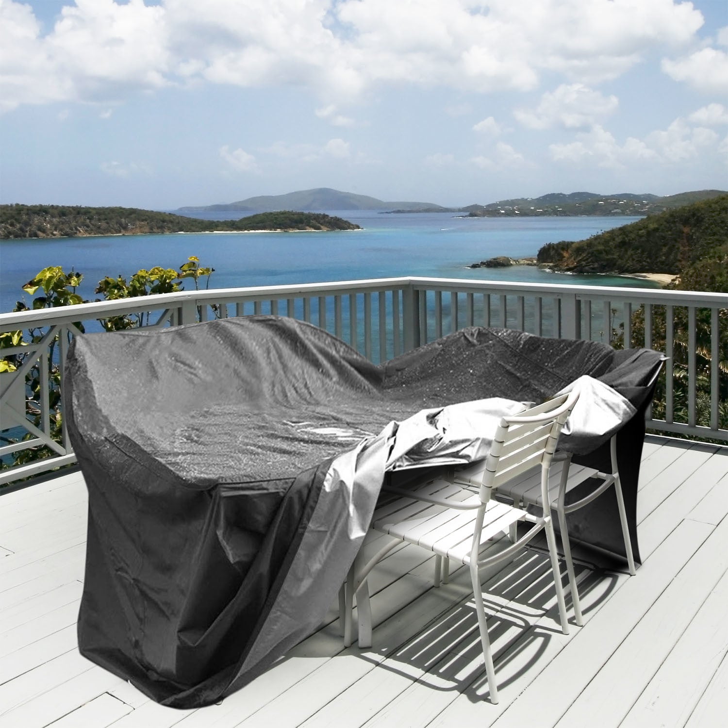 Large black 210D Waterproof Outdoor Furniture Cover made of Oxford cloth on a balcony, labeled as waterproof, anti-UV, windproof, and snow resistant, with an inset showing the cover in use and its storage bag.