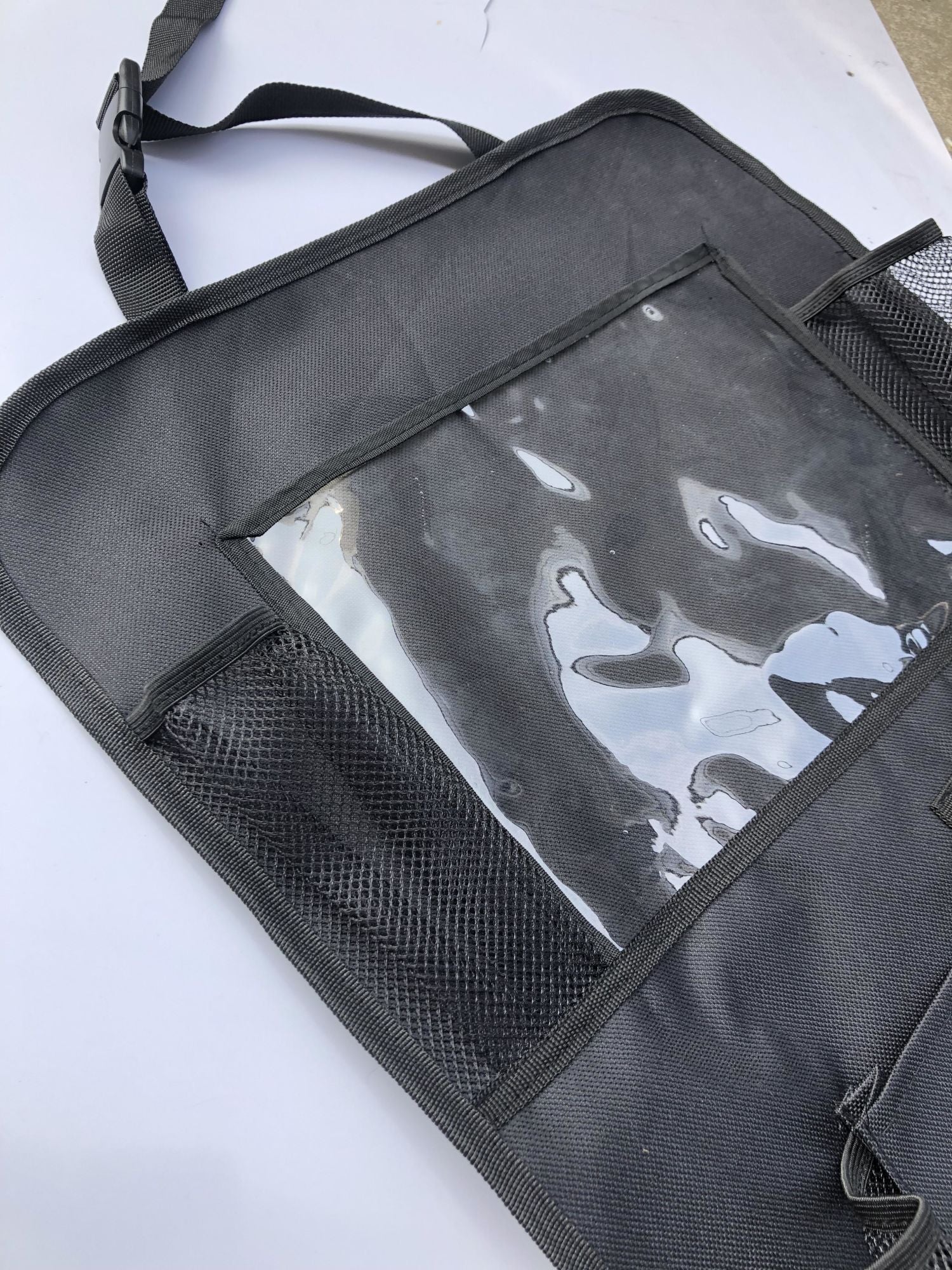 Two Backseat Car Organizers - 2PK, equipped with tablet holders and filled with items like bottles, snacks, and electronics, installed in a vehicle.