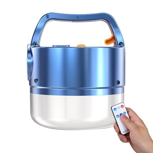 A blue 3N1 Solar Lantern With Remote hanging from a tree branch in a forest setting, ideal for outdoor adventures.