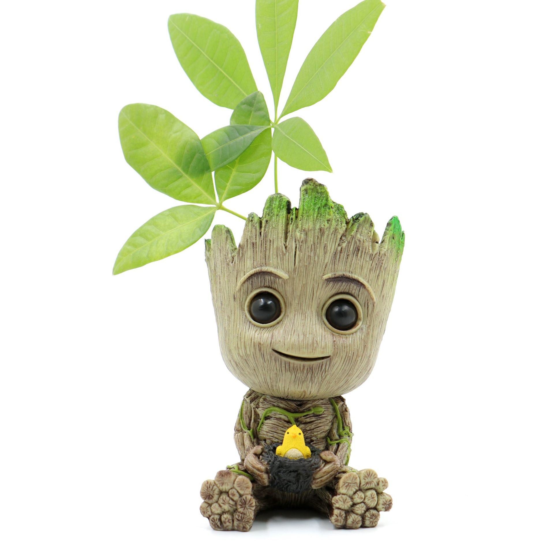 A Guardians of the Galaxy Groot Tree Man Hand Ornament, crafted from PVC, holding a small bird, with green leaves sprouting from its head, isolated on a white background.