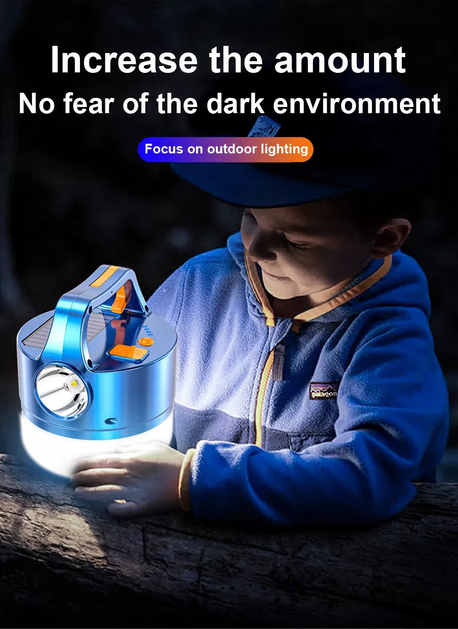 A blue 3N1 Solar Lantern With Remote hanging from a tree branch in a forest setting, ideal for outdoor adventures.
